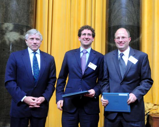Lee C. Bollinger (left) presents the 2011 Pulitzer Prize in National Reporting to Jesse Eisinger (center) and Jake Bernstein (right) of ProPublica.