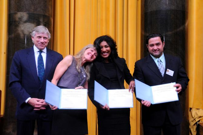 Lee C. Bollinger presents the 2011 Pulitzer Prize in Breaking News Photography to (l-r) Carol Guzy, Nikki Kahn and Ricky Carioti of The Washington Post.