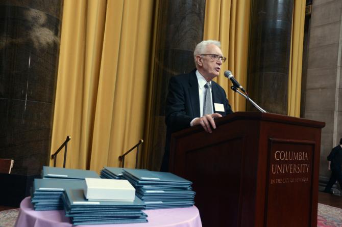 With a stack of Pulitzer Prize certificates by his side, Sig Gissler welcomes the luncheon guests.
