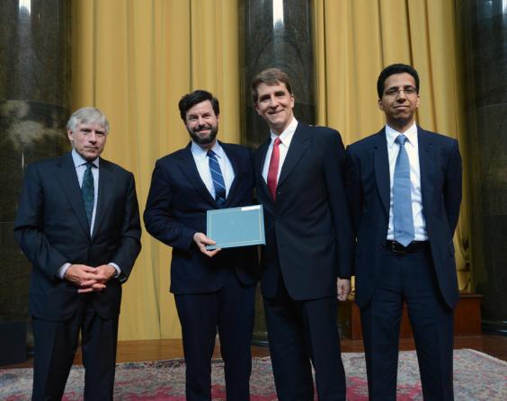 Lee C. Bollinger (left) presents the 2013 Pulitzer Prize in Explanatory Reporting to (left to right) Charles Duhigg, Keith Bradsher and David Barboza of The New York Times.