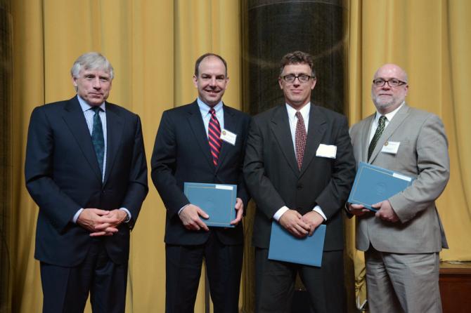 Lee C. Bollinger (left) presents the 2013 Pulitzer Prize in Local Reporting to (left to right) Brad Schrade, Jeremy Olson and Glenn Howatt of the Star Tribune.