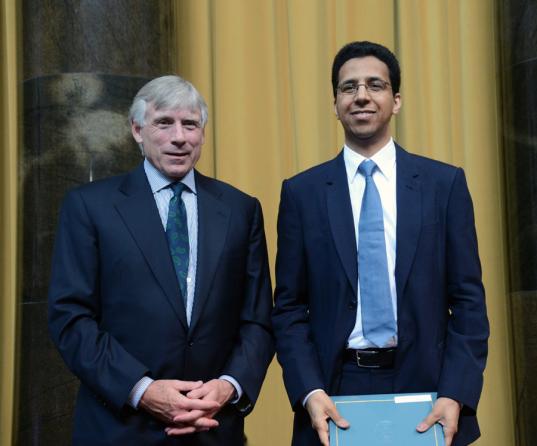 Lee C. Bollinger (left) presents the 2013 Pulitzer Prize in International Reporting to David Barboza of The New York Times.