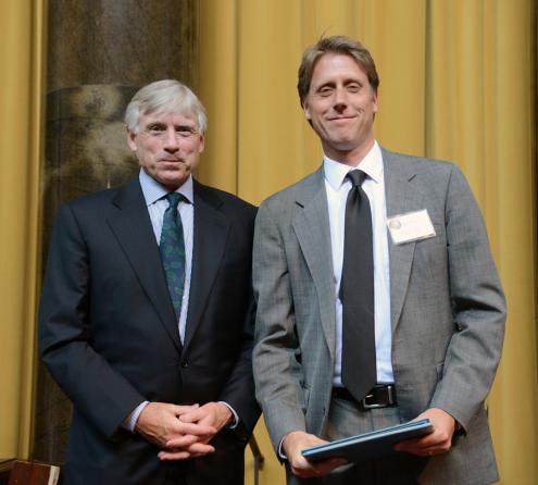 Lee C. Bollinger (left) presents the 2013 Pulitzer Prize in Feature Writing to John Branch of The New York Times.