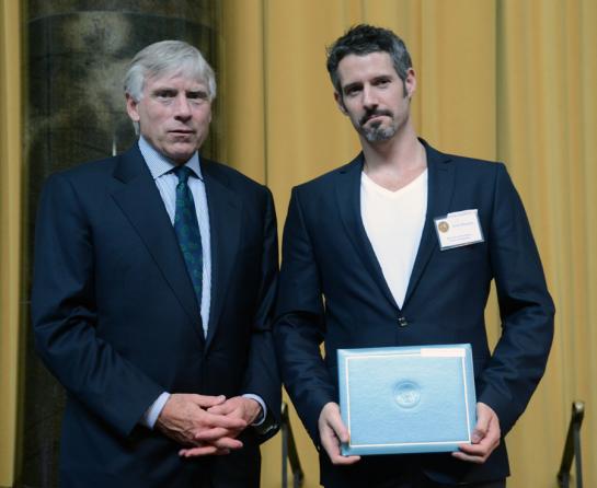 Lee C. Bollinger (left) presents the 2013 Pulitzer Prize in Feature Photography to Javier Manzano.