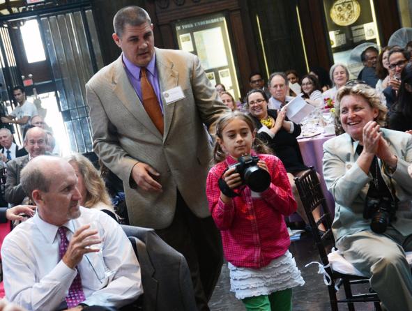Fiction winner Adam Johnson and his daughter, Jupiter, make their way to the podium.