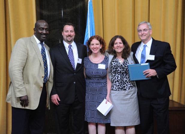 Gregory Moore (left) presents the 2012 Pulitzer Prize in Public Service  to (left to right) John Sullivan, Kristin Graham, Sue Snyder and Stan Wischnowski of The Philadelphia Inquirer.