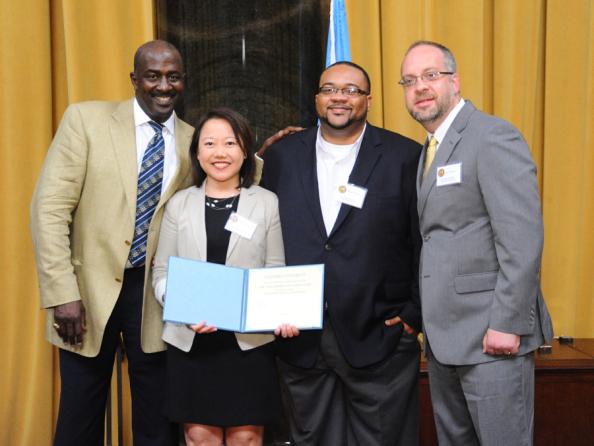 Gregory Moore (left) presents the 2012 Pulitzer Prize in Breaking News Reporting to (left to right) Katherine Lee, Jamon Smith and Jason Morton of The Tuscalossa (Ala.) News.