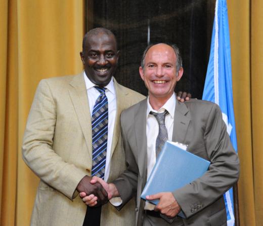 Gregory Moore (left) presents the 2012 Pulitzer Prize in Feature Photography to Craig F. Walker of The Denver Post.